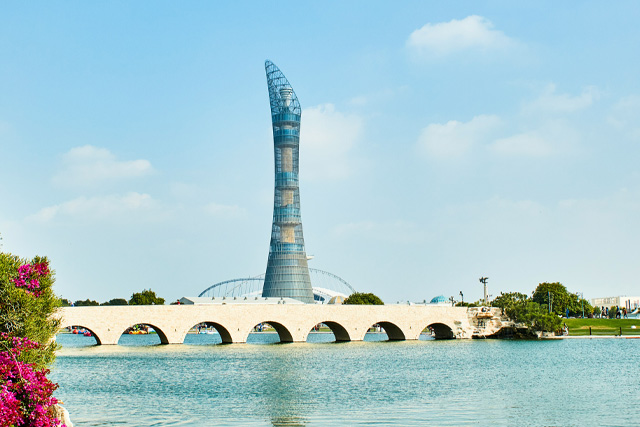 Aspire Park in Doha, Qatar, featuring lush greenery, a serene lake, and walking trails.