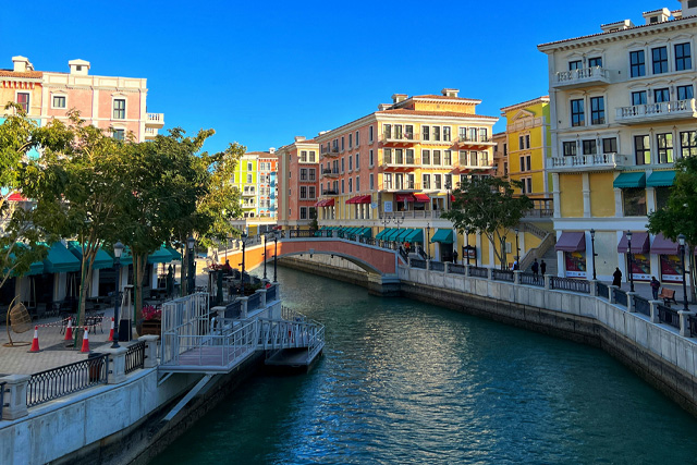 Picturesque canal and colorful buildings at The Pearl-Qatar, a luxurious waterfront destination in Doha.